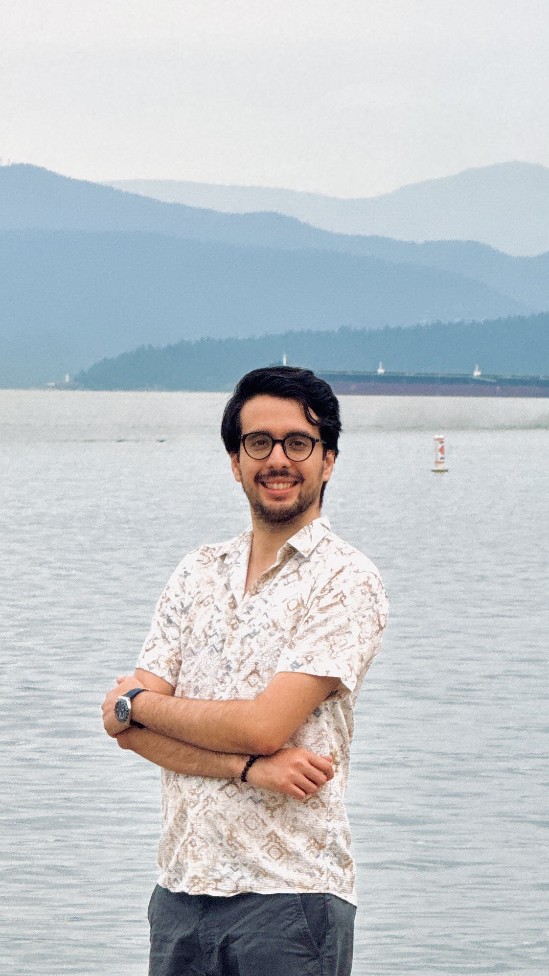 Hamid Hassani smiling in a colorful setting